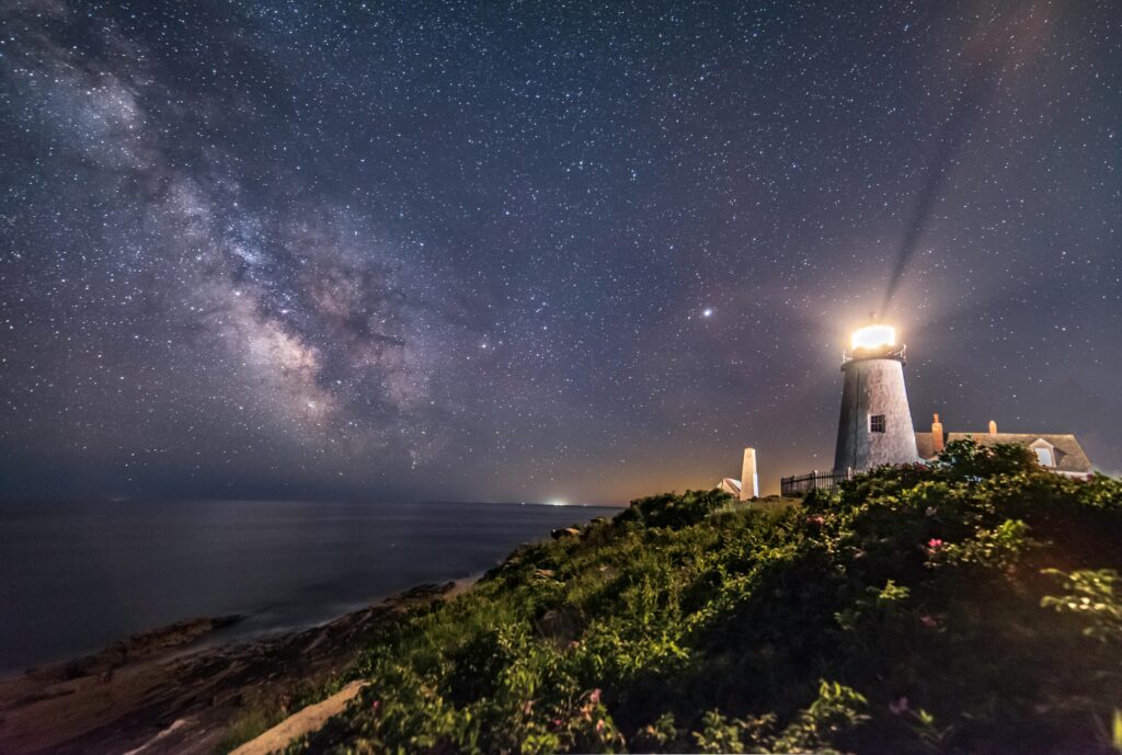 lighthouse at night with starry sky